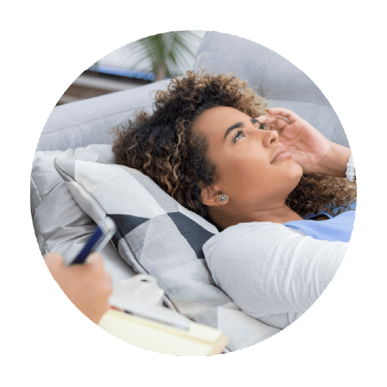 A woman resting comfortably on a couch